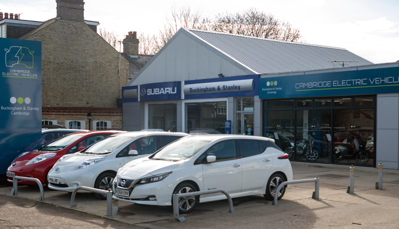 Front of Buckingham and Stanley dealer showing cars on forecourt and company sign above doors